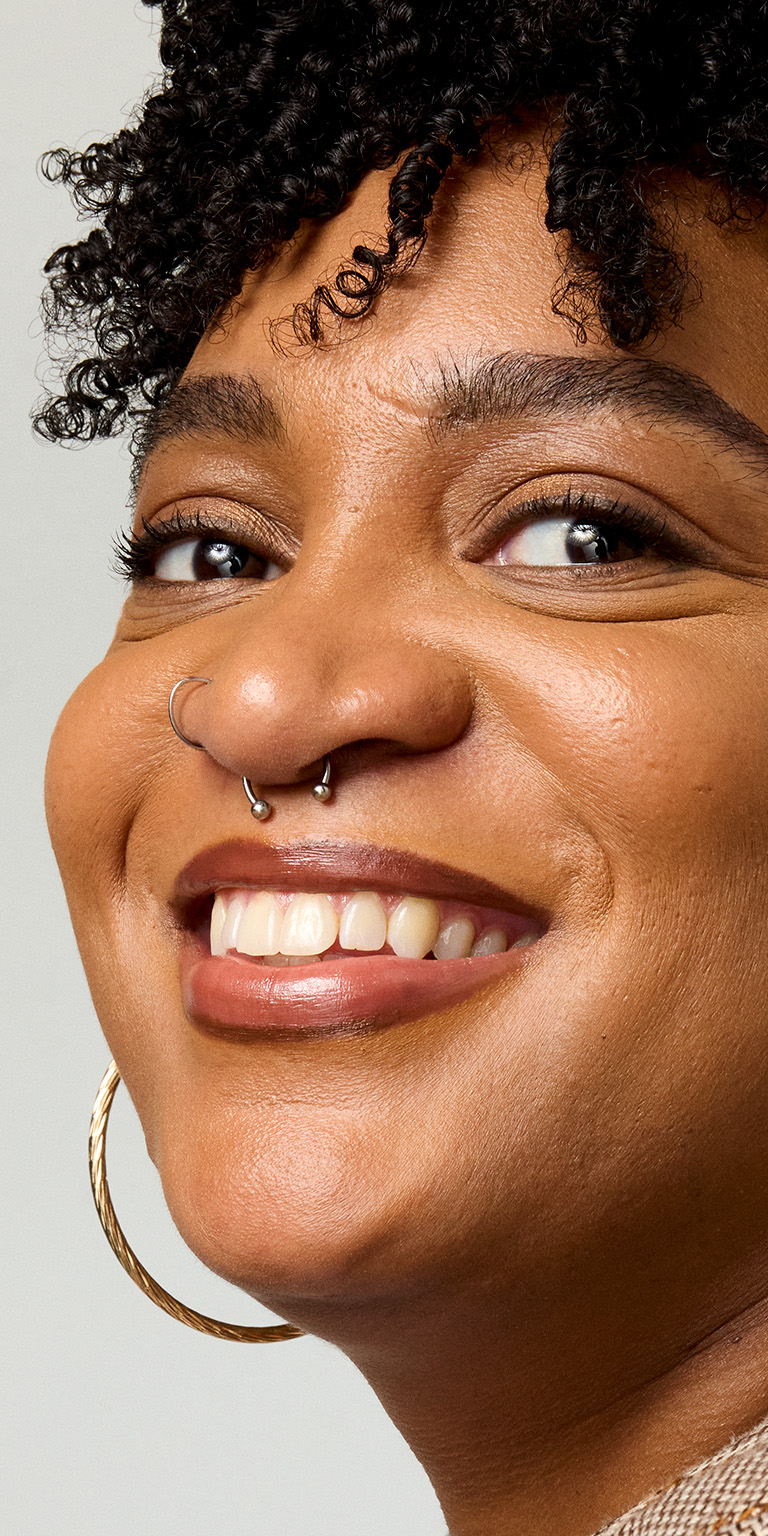 Profile view of woman smiling at the camera