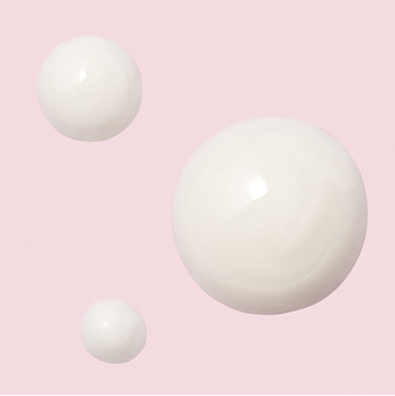 Droplets of Mary Kay TimeWise Replenishing Serum C+E on a pink background